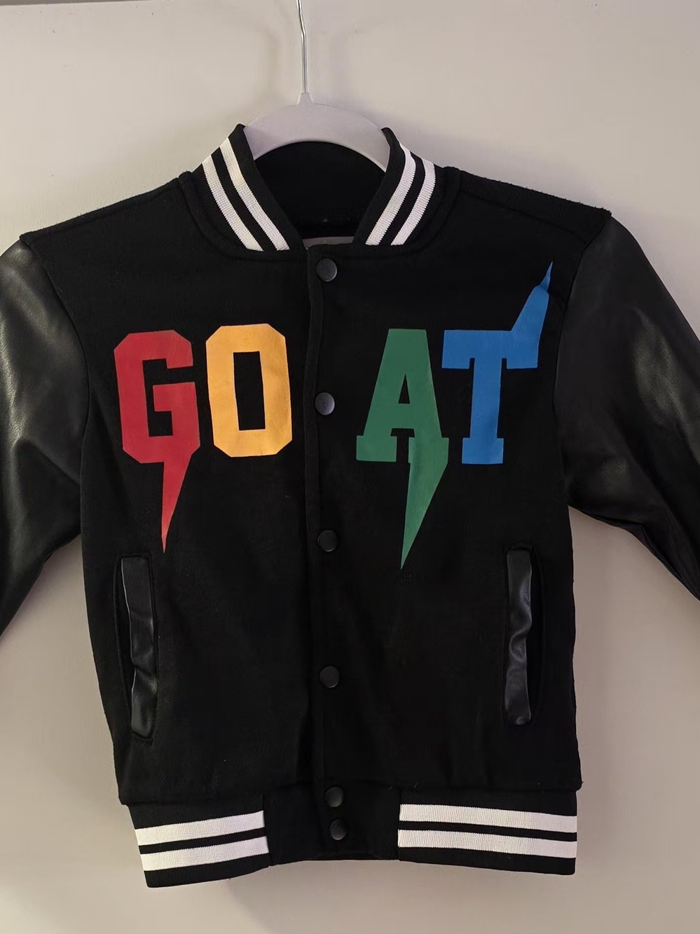 Dry Goods Black Varsity Jacket with Red, Yellow, Green, and Blue Lettering